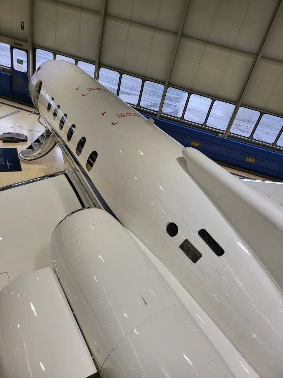 Private jet tail and fuselage detail in the hangar